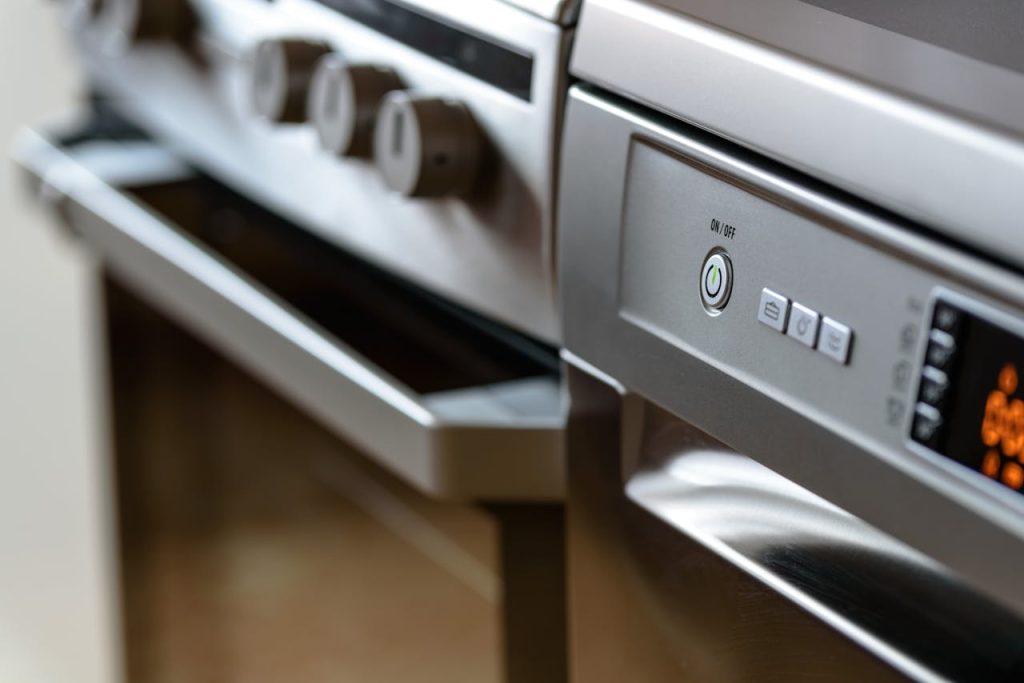 close-up-photo-of-dishwasher-213162 Close-up view of modern stainless steel kitchen appliances with focus on dishwasher and oven.